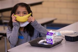Girl shows off her banana smile 